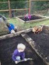 Photo of garden with children and chickens